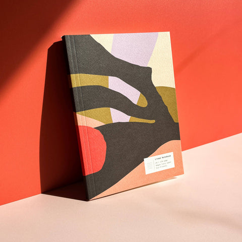 Book with abstract design on a red and beige background