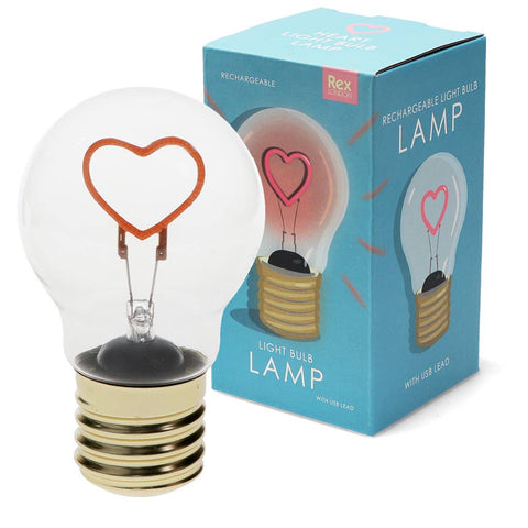 Clear light bulb with heart-shaped filament and packaging on a white background
