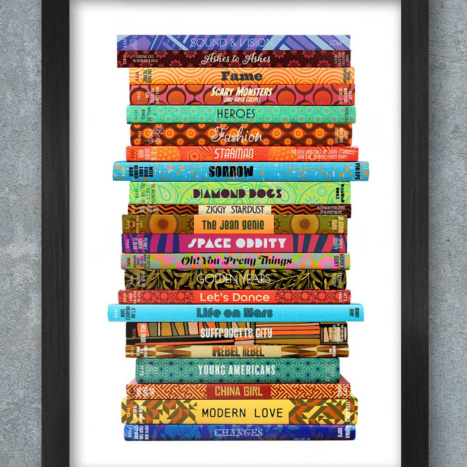 Framed artwork of colorful book spines stacked on a gray background