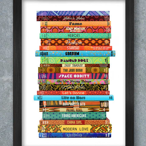 Framed artwork of colorful book spines stacked on a gray background