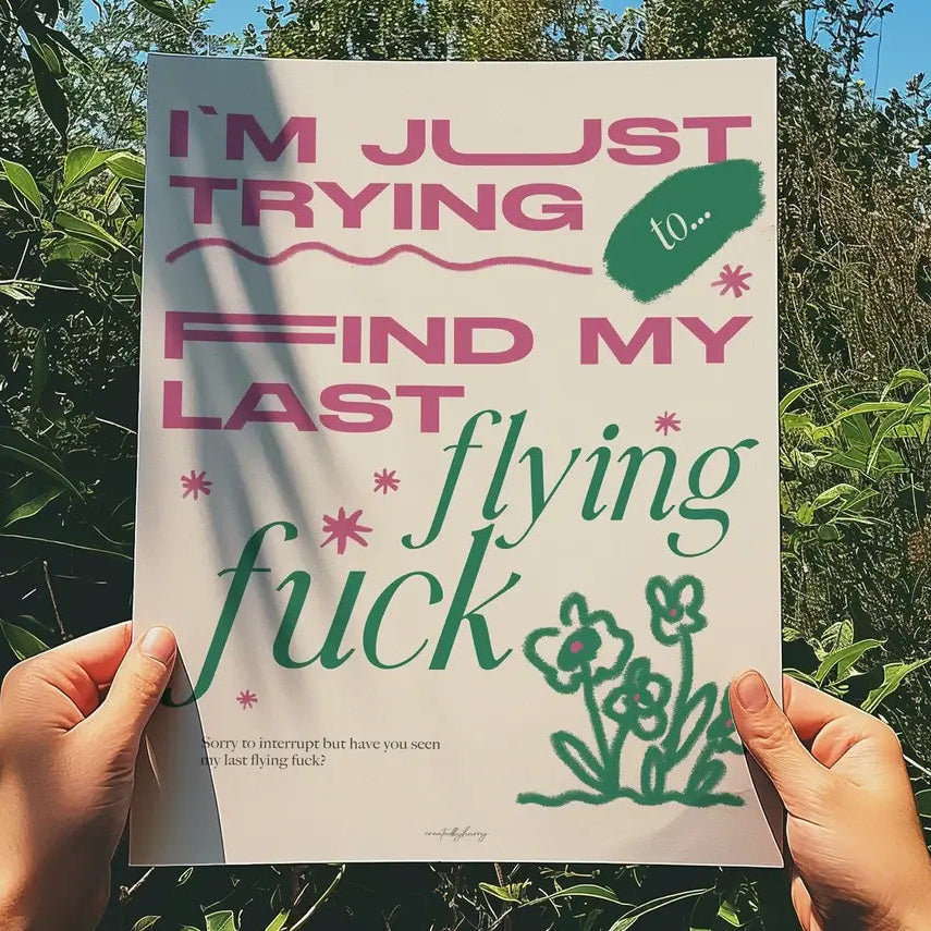 Person holding a poster with text and illustrations against a natural background