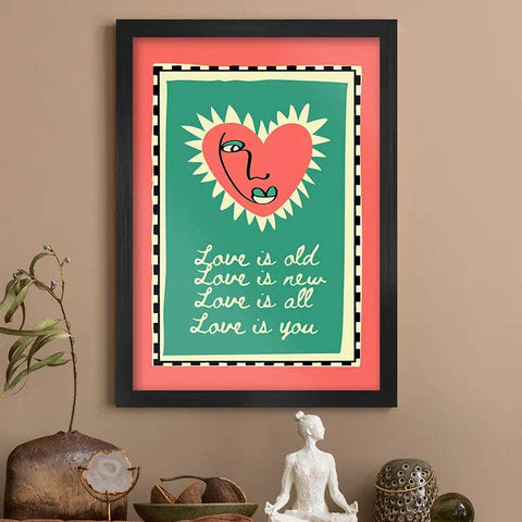 Framed artwork with a heart design and text on a wall above a sofa.