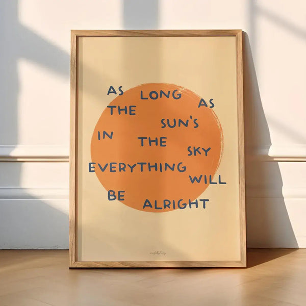 Framed artwork with an orange circle and text on a wooden floor.