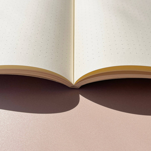 Open notebook with beige pages on a matching background
