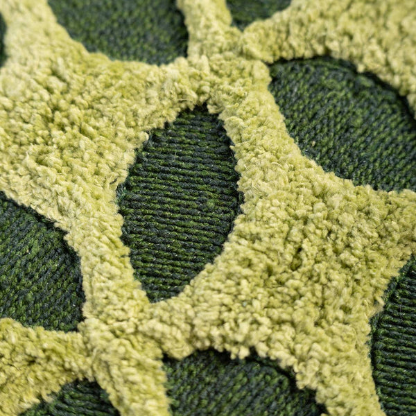 Close-up of a textured green fabric with a star pattern