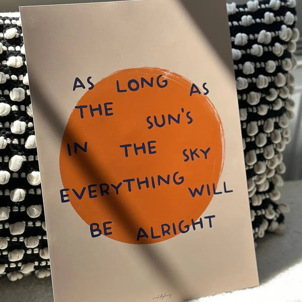 Poster with motivational quote 'As long as the sun's in the sky everything will be alright' on a beige background.