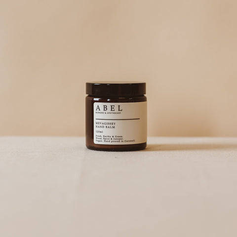 Jar of cream with a label on a beige background