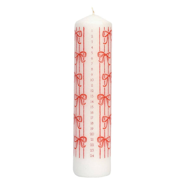White candle with red bow pattern and measurements on a white background