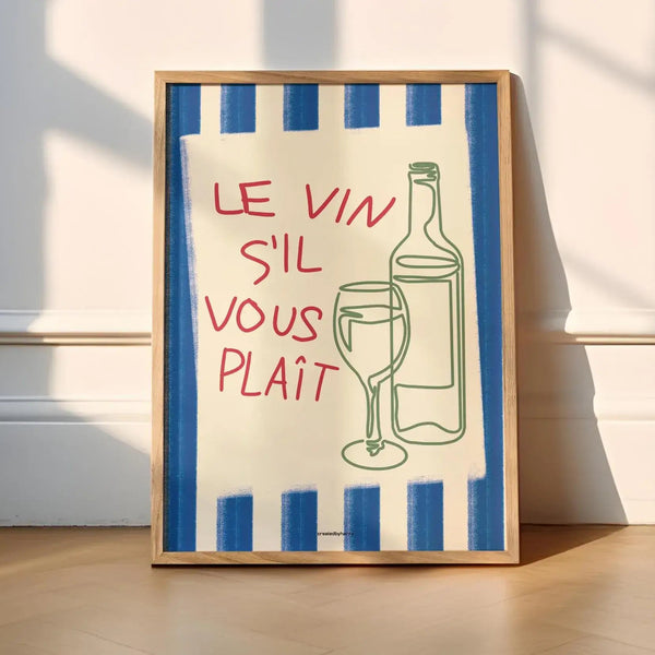 Framed artwork with a blue and white striped border, red text, and a bottle and glass illustration on a light wooden floor.