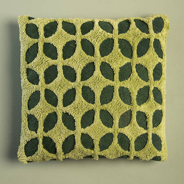 Green pillow with leaf pattern on a beige background